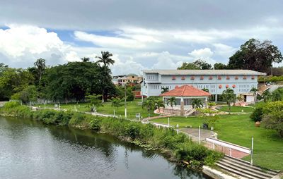 buildings beside a river surrounded by trees