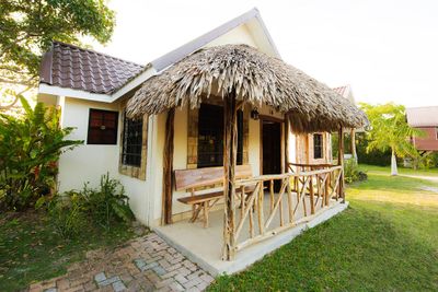 small house with palapa roof over verandah