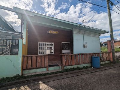 small streed-side house with wooden wall