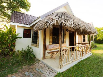 small house with palapa roof over verandah