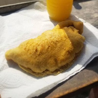 fried dough with orange juice in bottle beside it