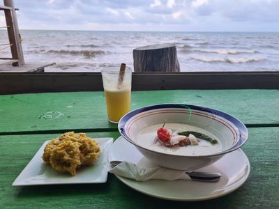 plate of soup with sea in background