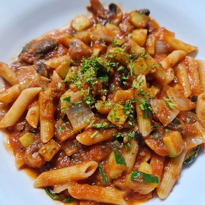 red pasta with cilantro sprinkled