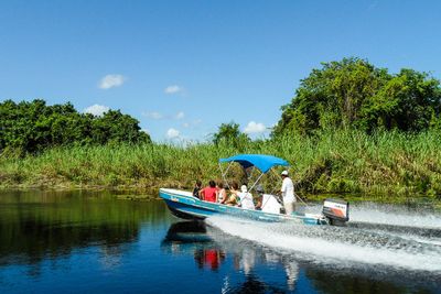 boat in river with bush as background