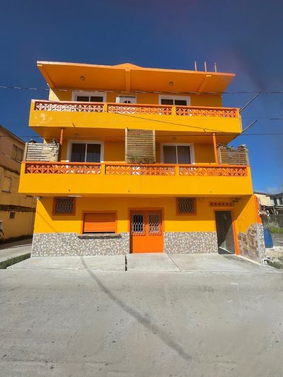 three story yellow and orange building