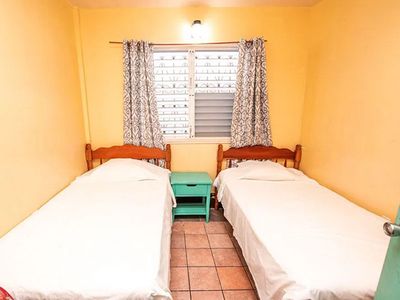 two beds in yellow bedroom