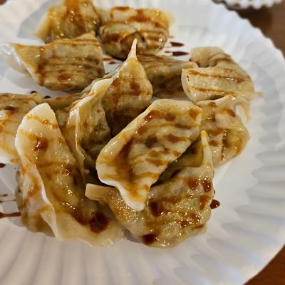 dumplings with black sauce on it