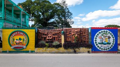 murals of town council, mayan temple and belize flag