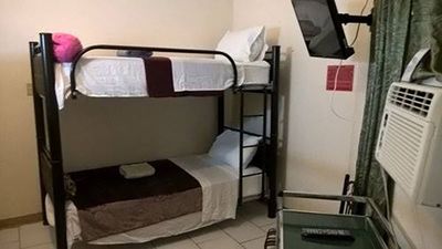 room with bunk bed, air conditioning and television