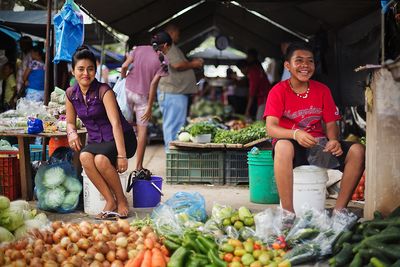 local vendors smiling at farmers market