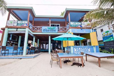 two story blue building with bar and restaurant downstairs