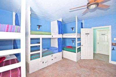 three sets of bunkbeds in blue room