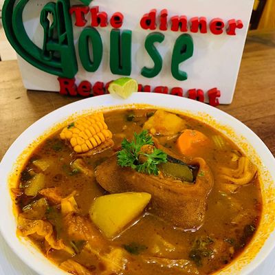 big bowl of cow foot soup with restaurant logo as background