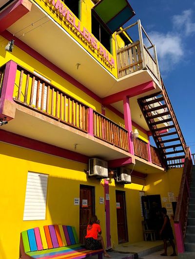 yellow and pink three story building with stairs