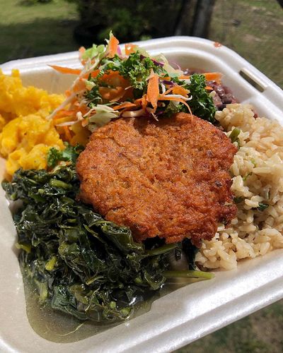 vegetarian plate with greens, faux meat, rice and vegetables